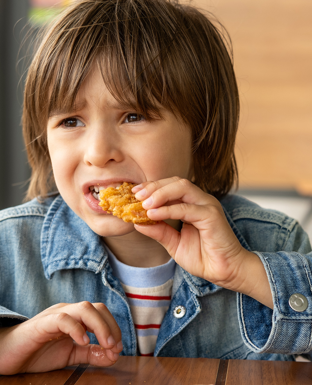 Junior worker eating a chicken nugget