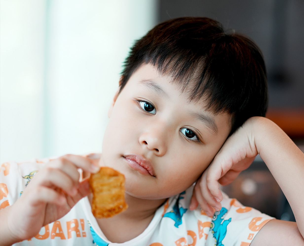 Junior worker holding a chicken nugget